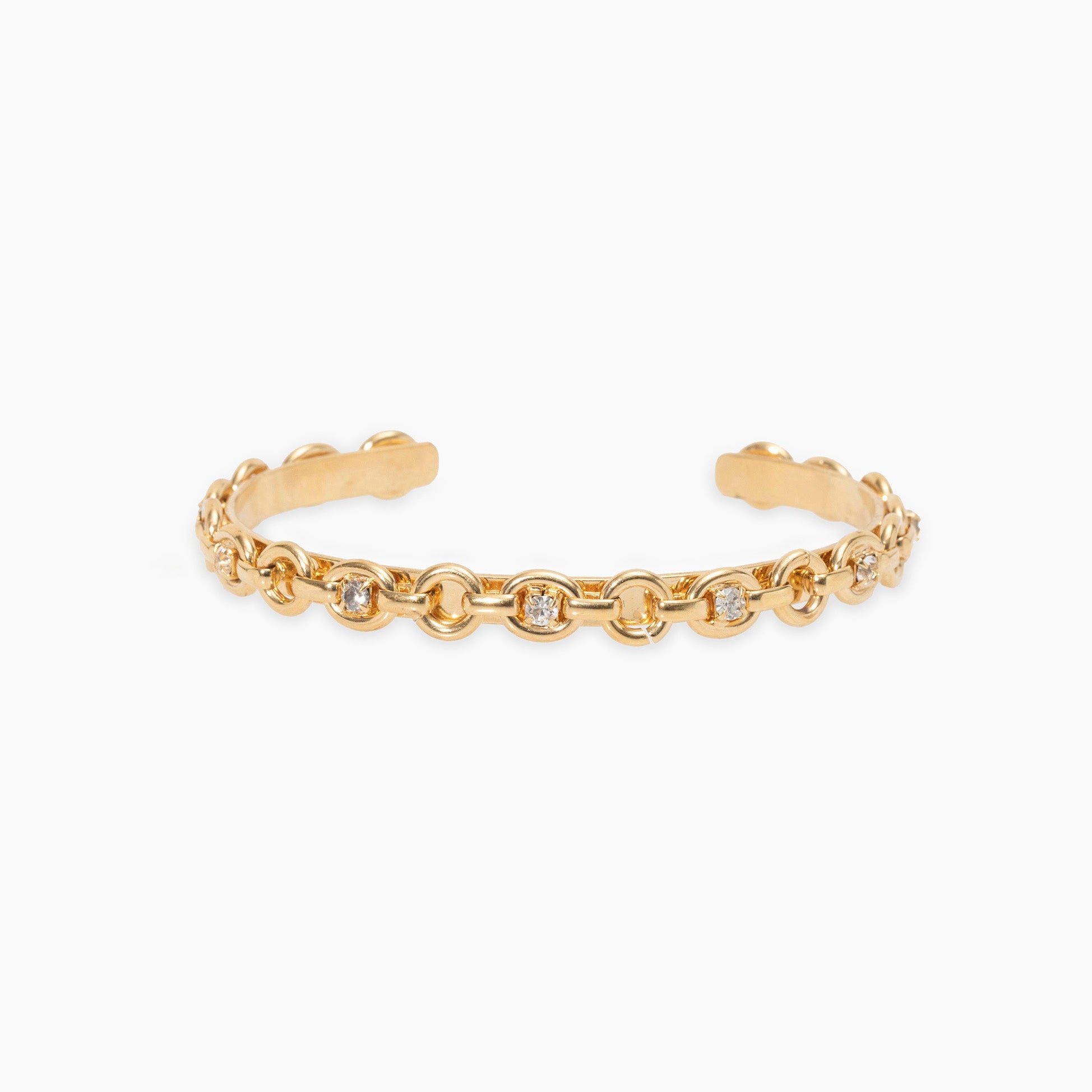 Gold chain cuff bracelet with small crystals on a white background