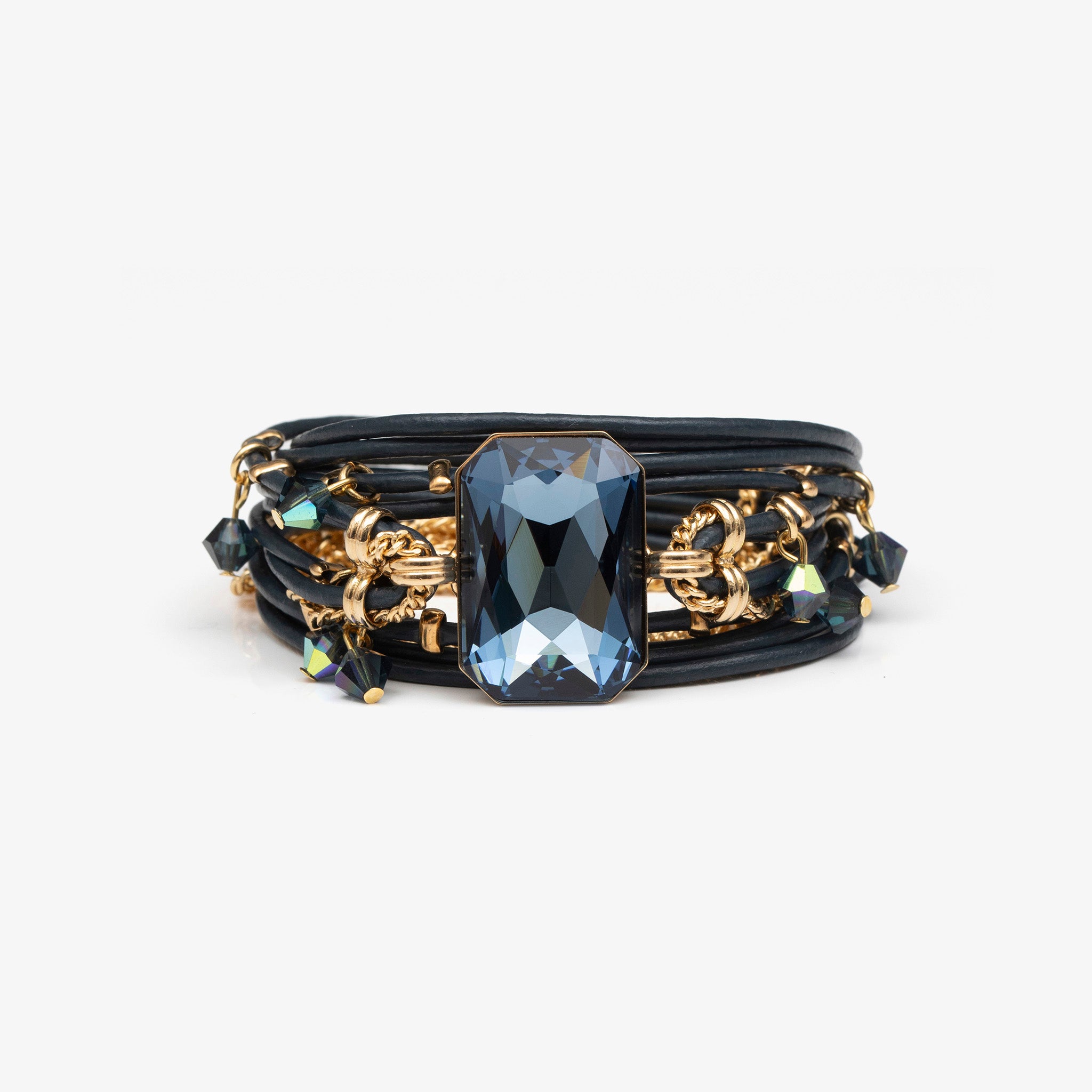 Black and gold bracelet with a large blue gemstone on a white background