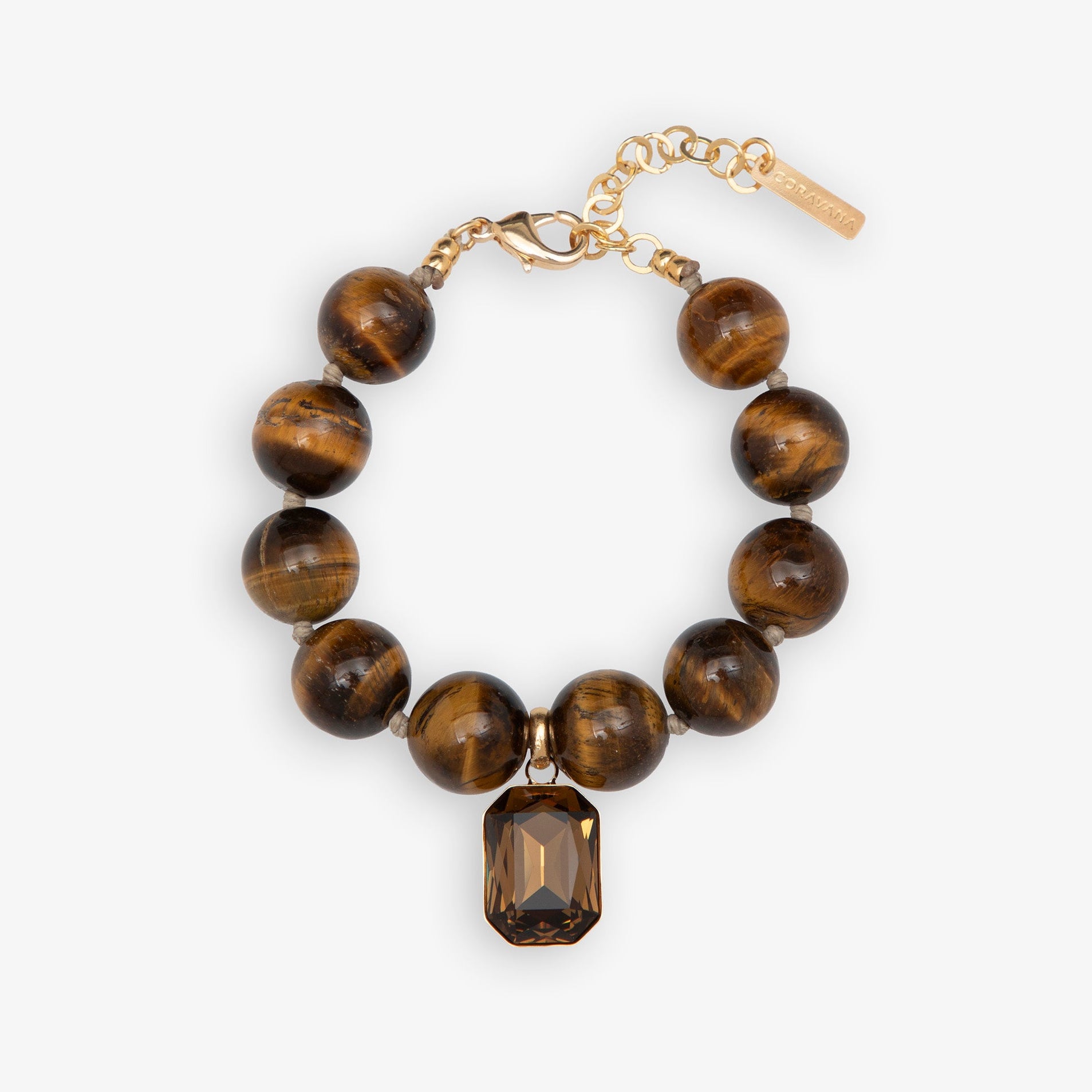Bracelet with tiger eye beads and a gold chain on a white background