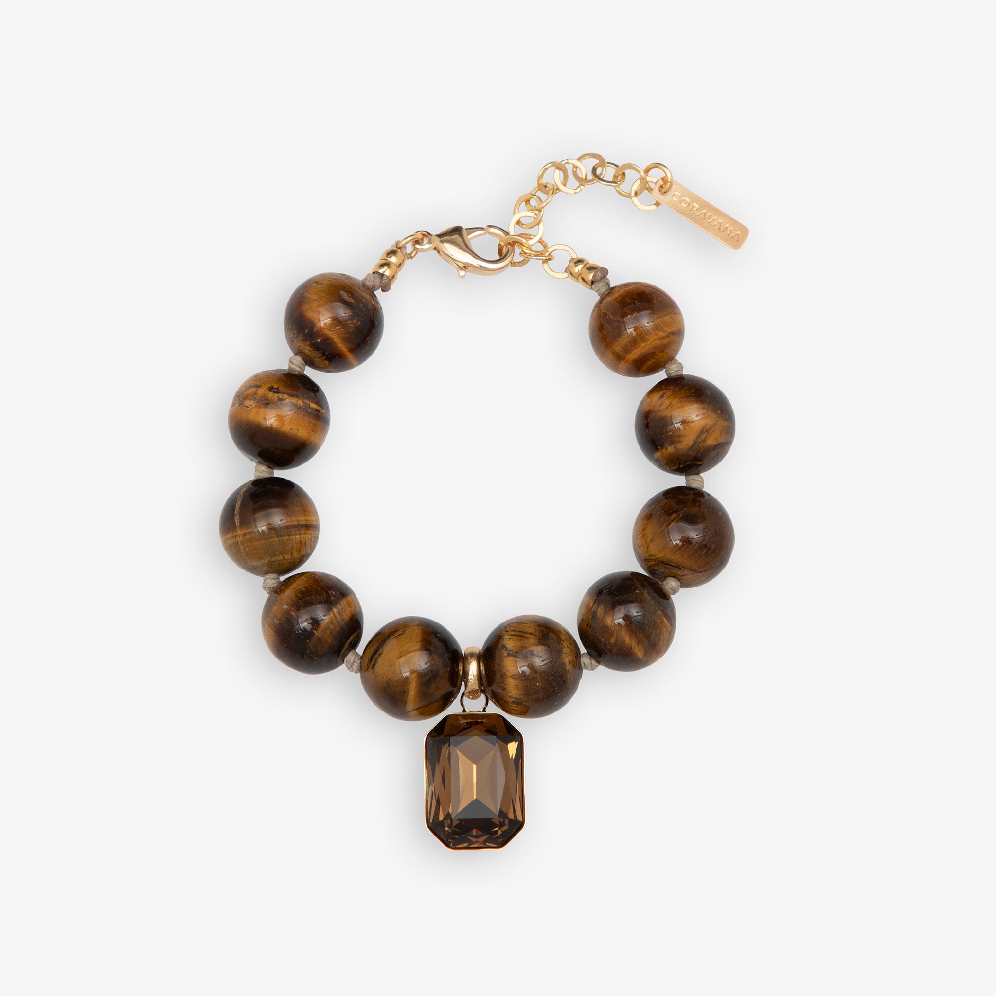 Bracelet with tiger eye beads and a gold chain on a white background