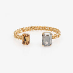Two gold rings with gemstones on a white background
