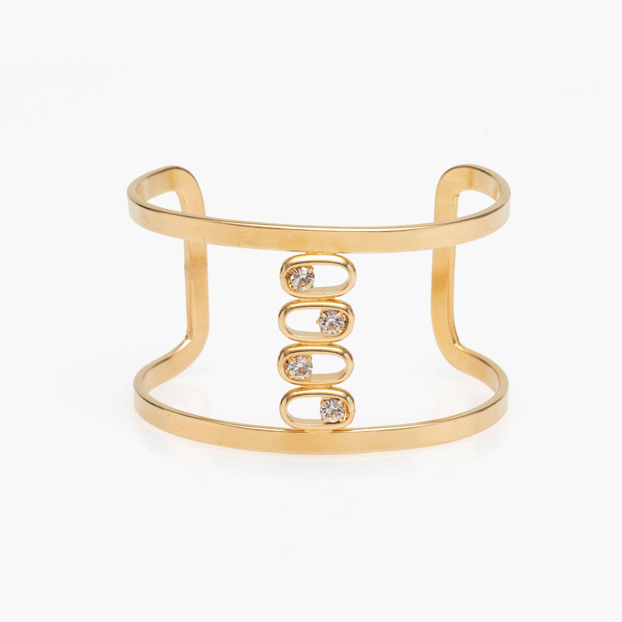 Gold cuff bracelet with embedded crystals on a white background