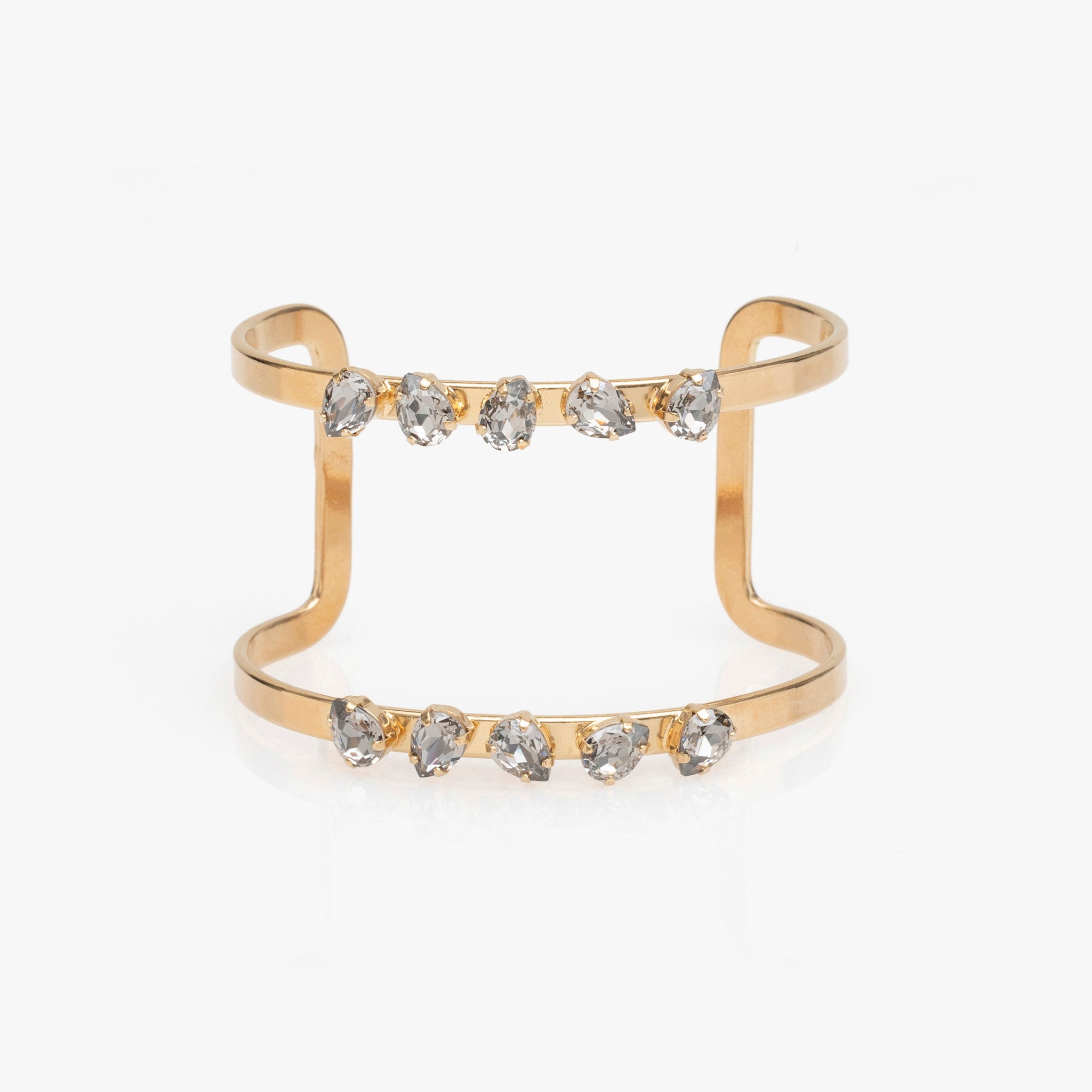 Gold bracelet with embedded crystals on a white background