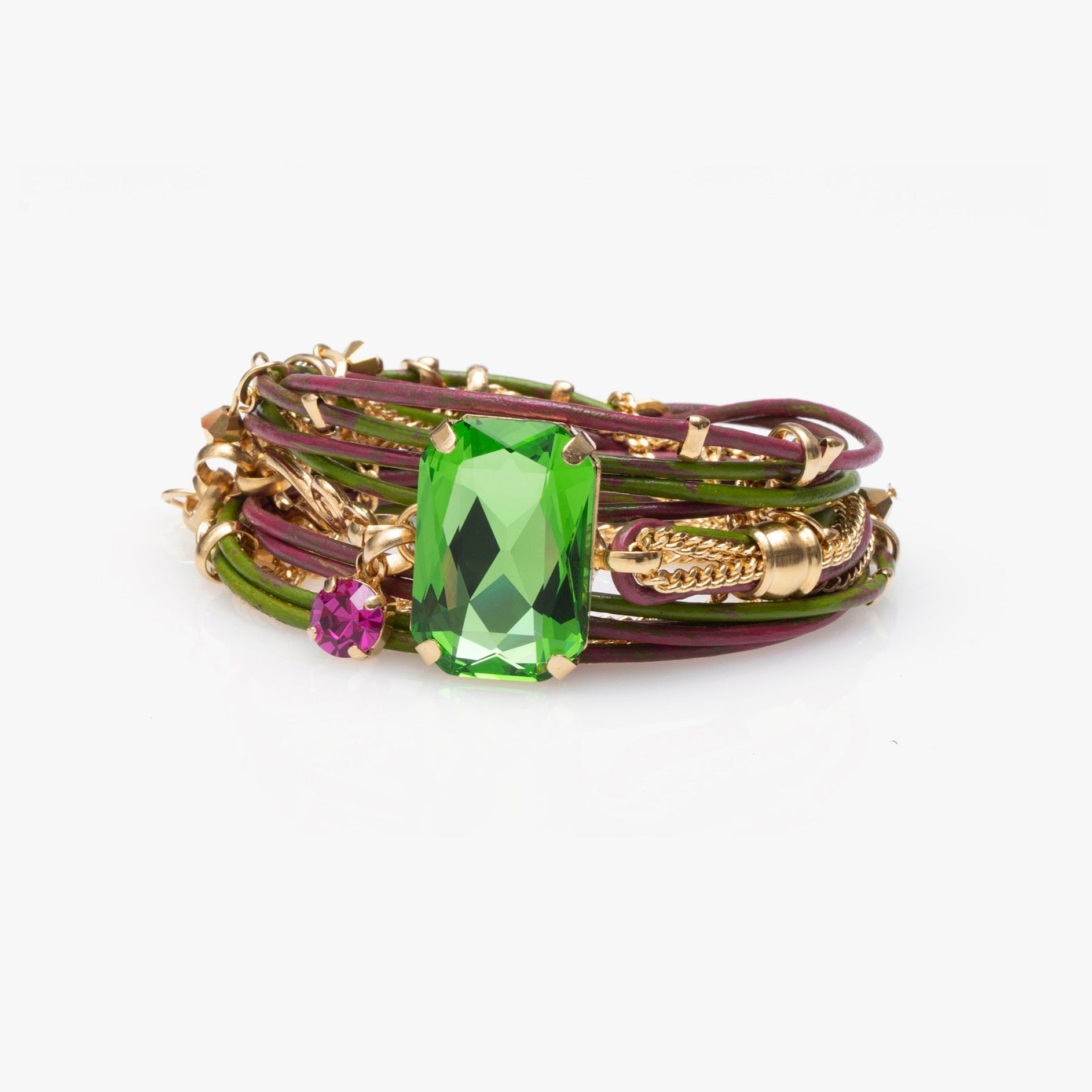 Multistrand bracelet with a green gemstone and purple bead on a white background