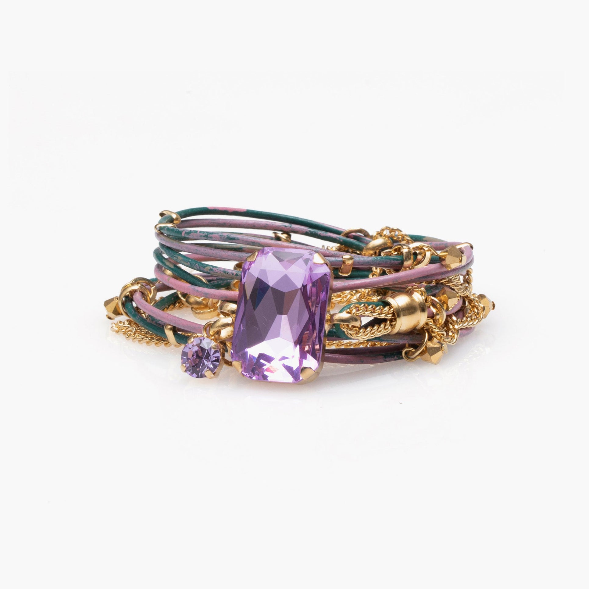 Stack of gold and purple gemstone rings on a white background