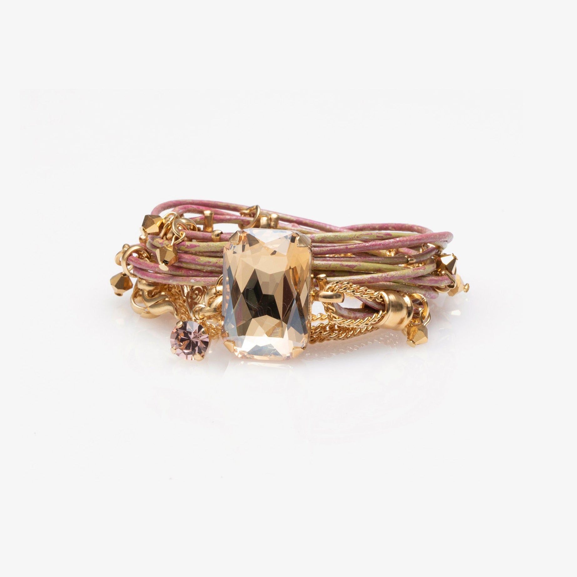 Gold and purple bracelet with a central gemstone on a white background