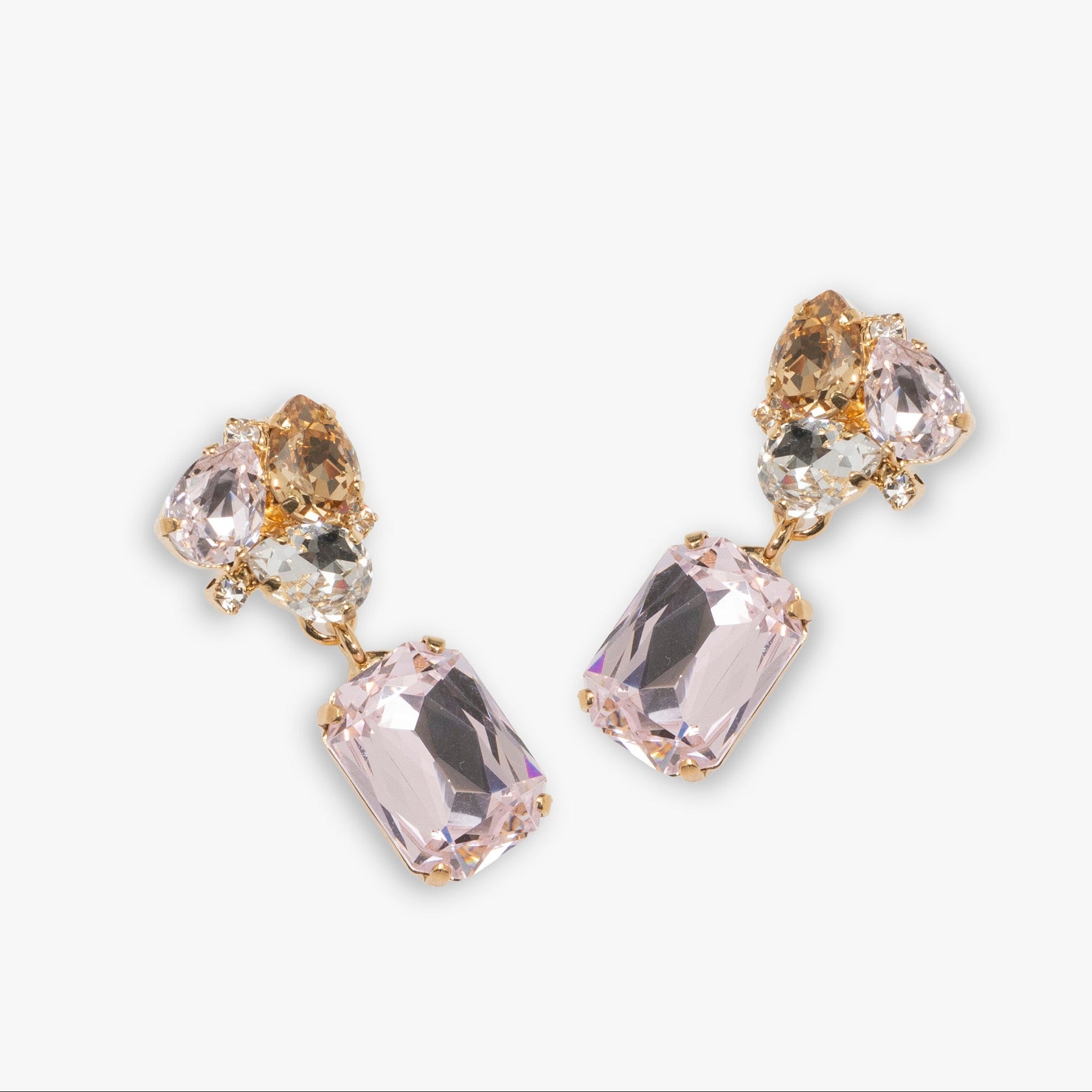 Pair of earrings with clear and gold gemstones on a white background