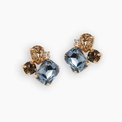 Pair of earrings with blue and brown gemstones on a white background