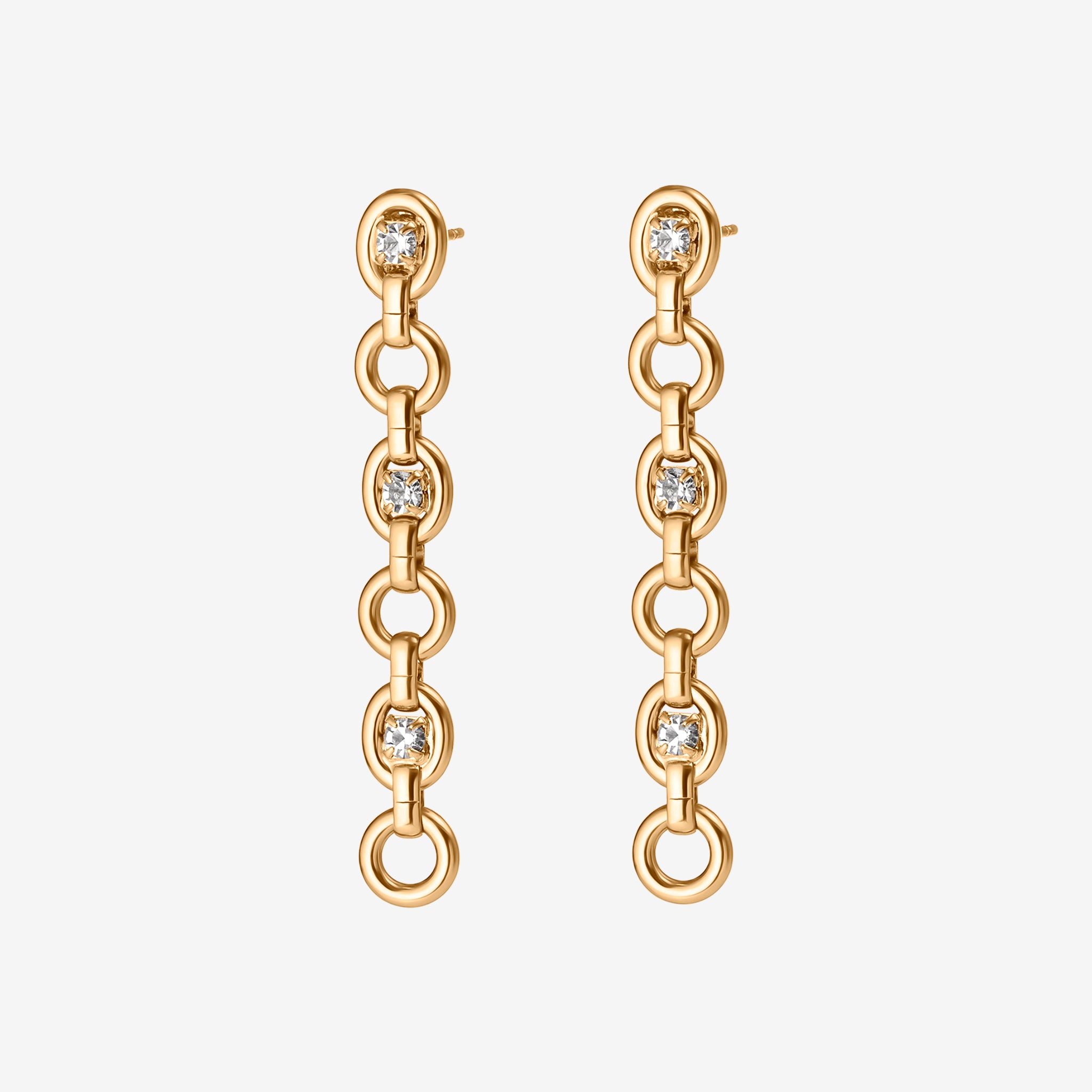 Gold chain earrings with diamond-like stones on a white background