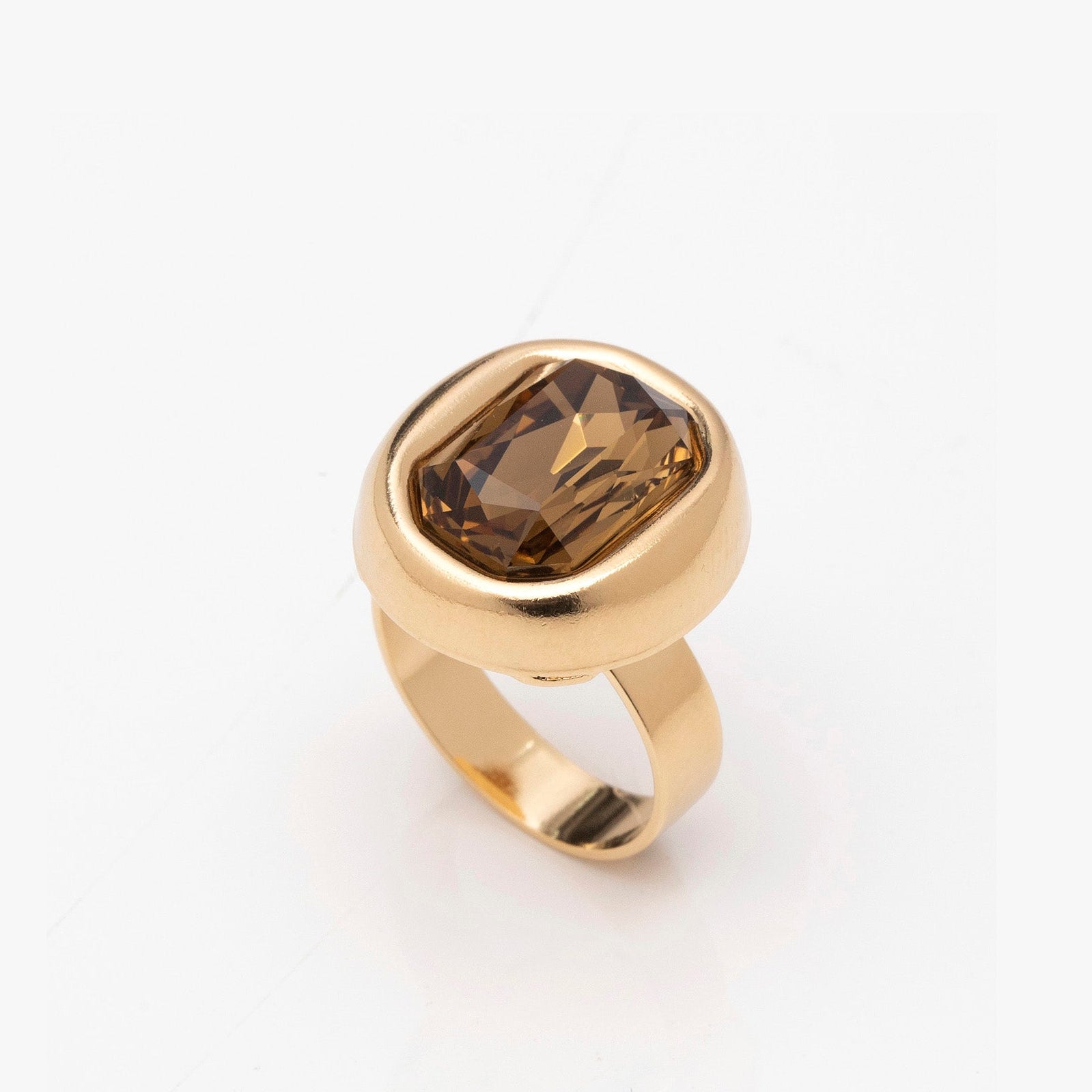 Gold ring with a smoky top stone on a white background