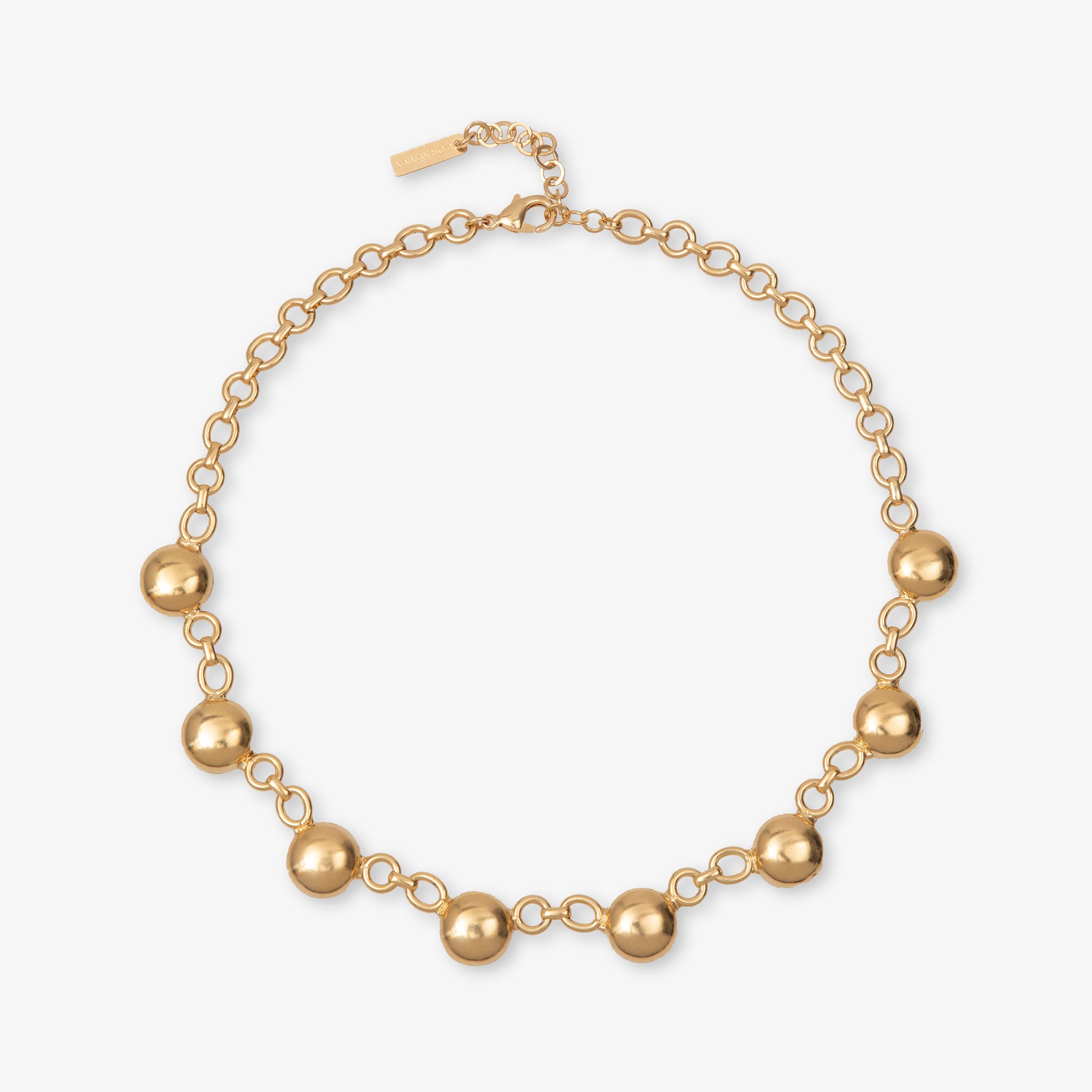 Gold necklace with spherical beads on a white background