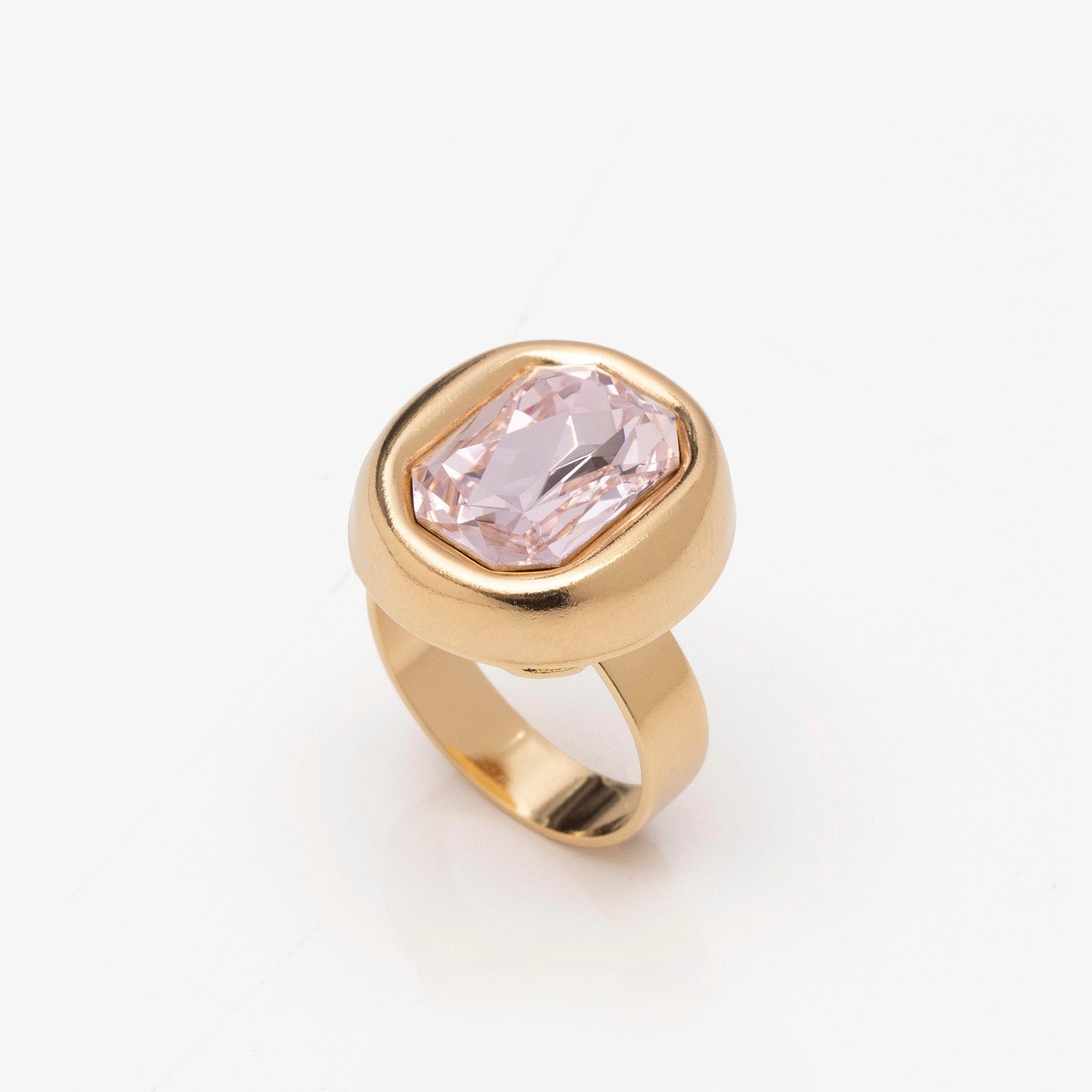 Gold ring with a pink gemstone on a white background