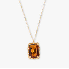 Necklace with a rectangular brown gemstone pendant on a white background