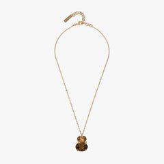 Gold necklace with a pendant on a white background