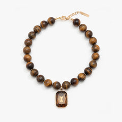 Necklace with brown beaded chain and rectangular pendant on a white background
