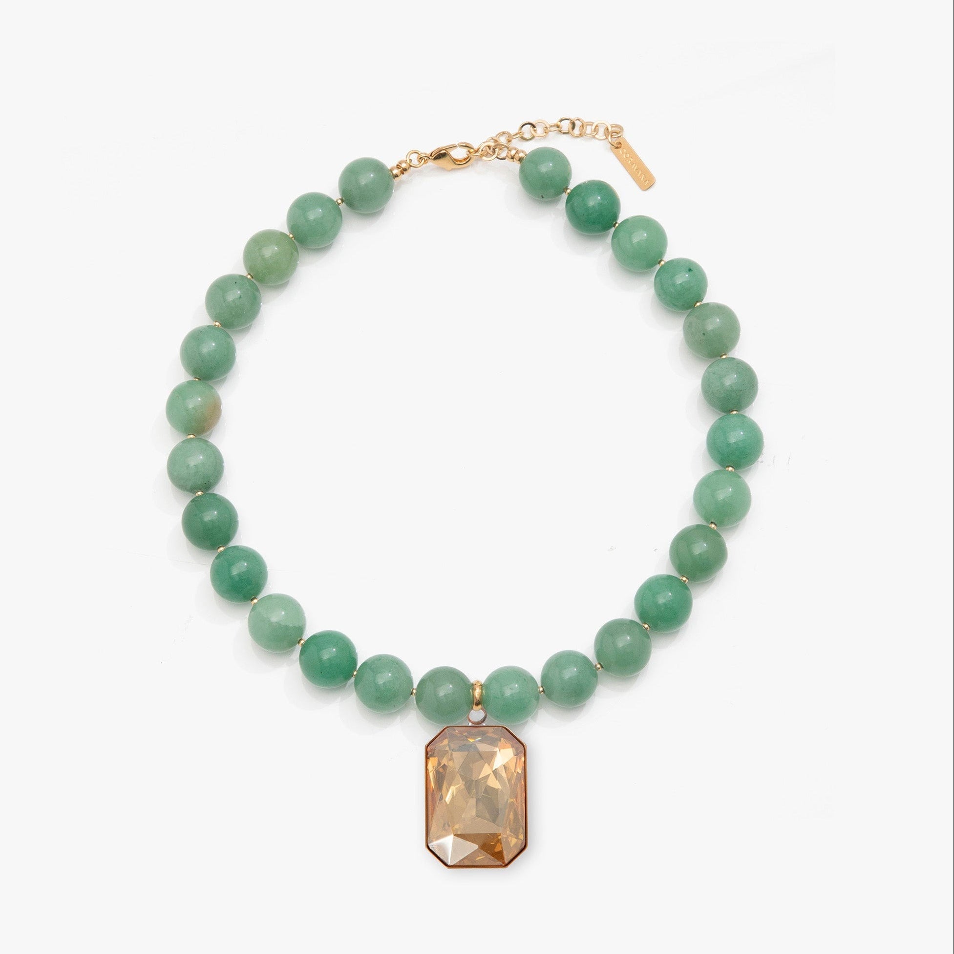 Necklace with green beads and a rectangular brown pendant on a white background