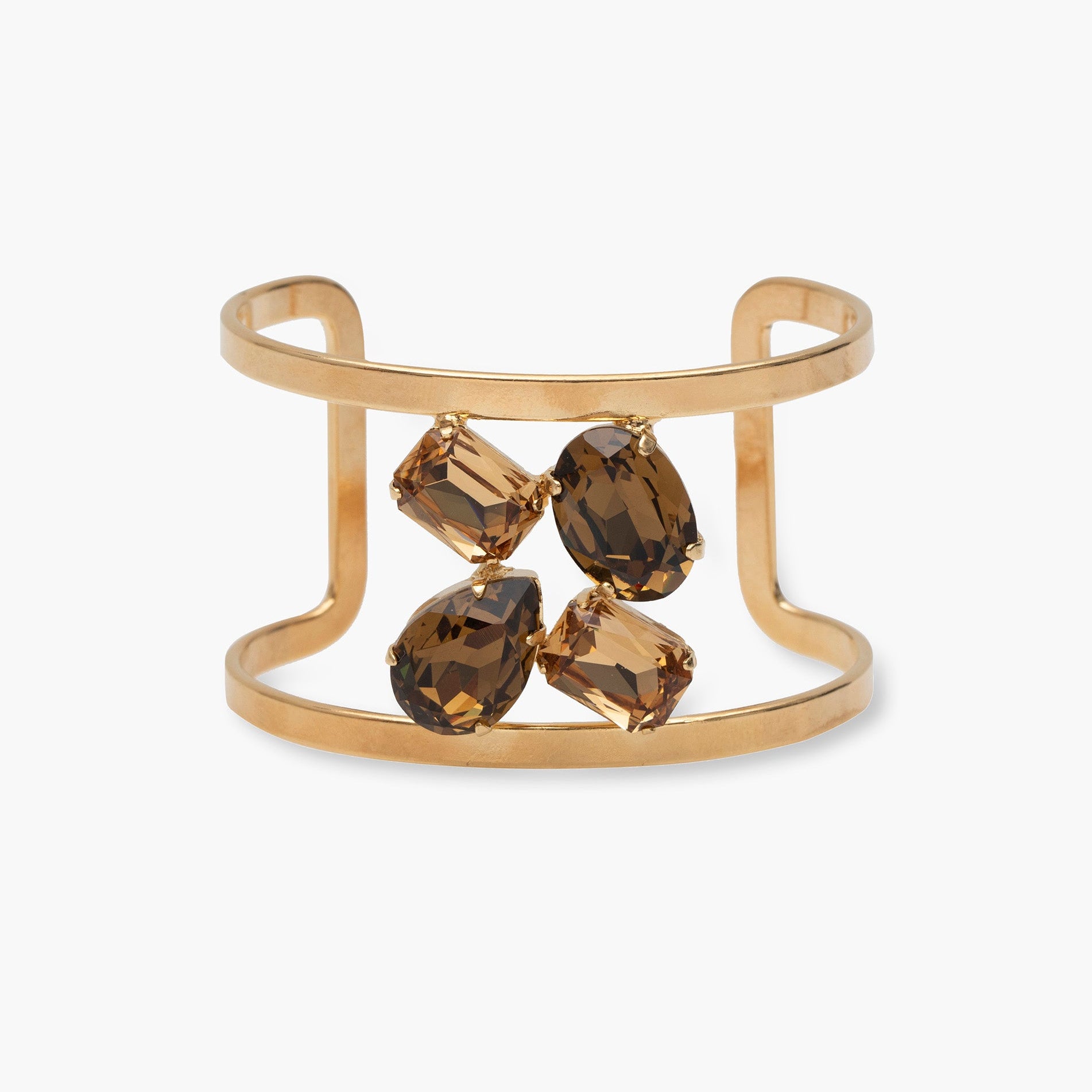 Gold cuff bracelet with smoky brown gemstones on a white background