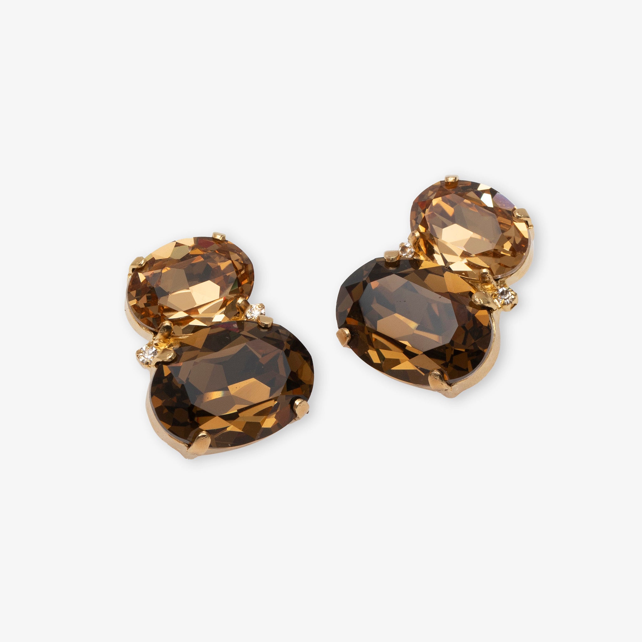 Pair of gold and brown gemstone earrings on a white background